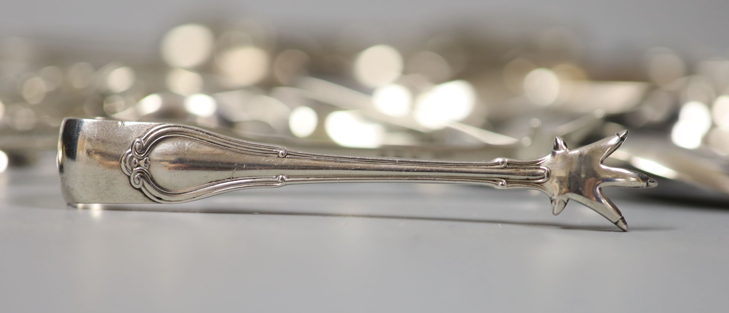 A quantity of assorted silver flatware including Georgian and later sugar tongs, condiment spoons etc.18oz.